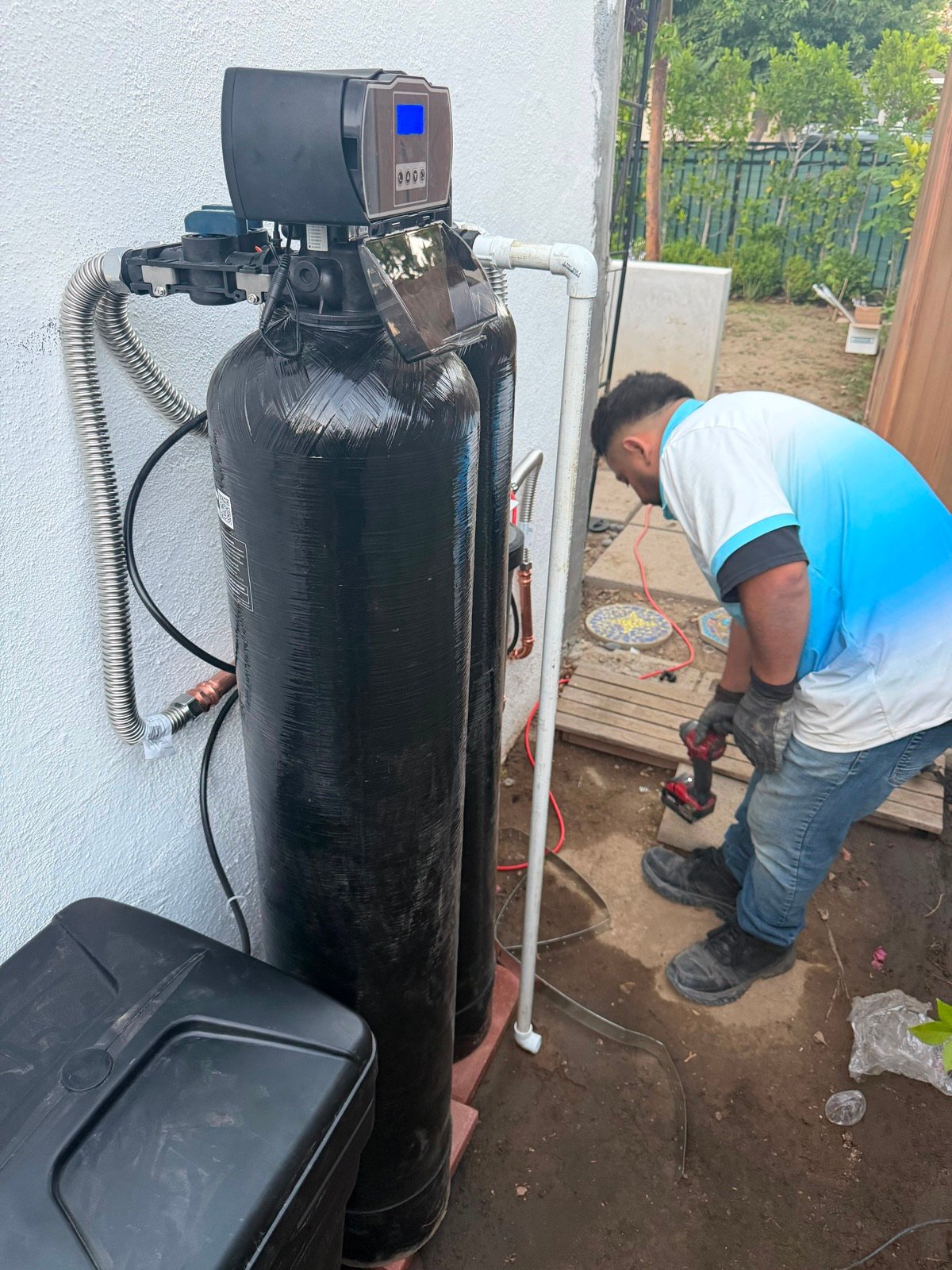 Lima Water Systems technician installing a whole-house filtration system